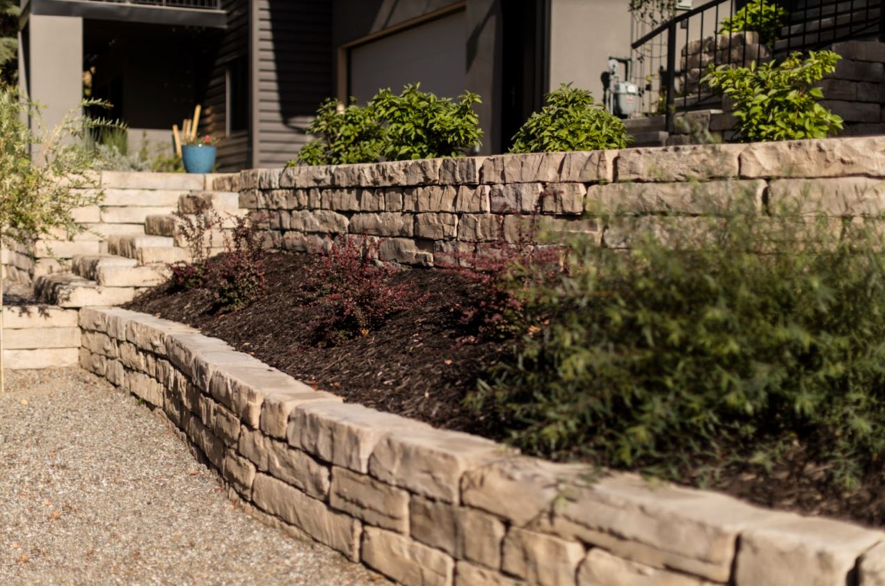 Kodah wall with fine linear stone coursing and planting above